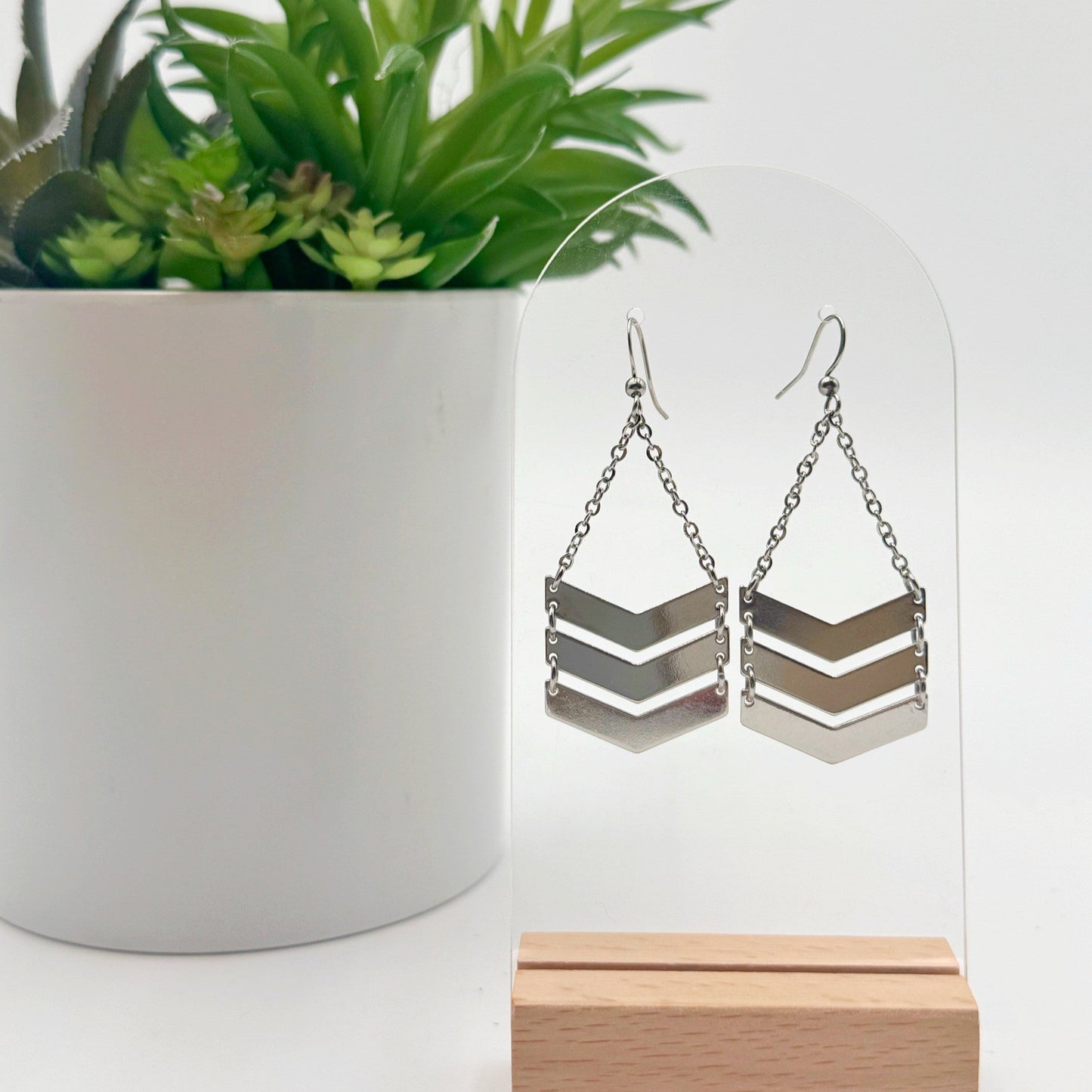 minimal chevron pattern earrings with neutral tones.