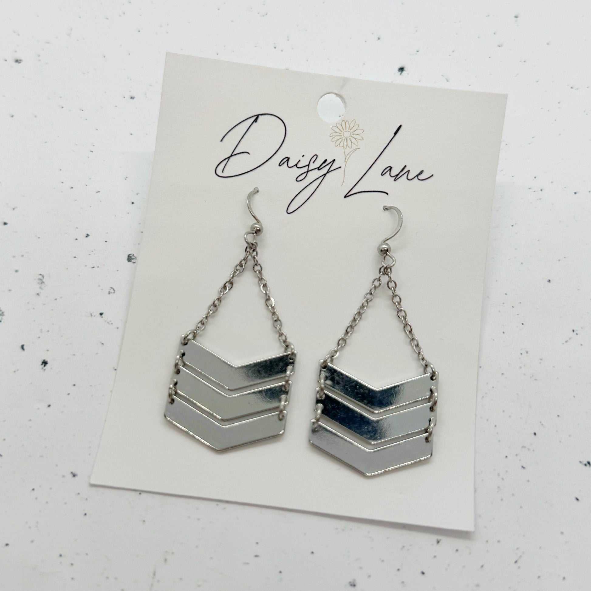 Chevron patterned earrings on a 'Daisy Lane' branded card against a white background